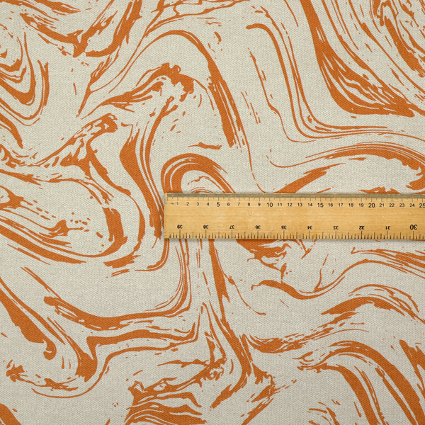 Abstract marbled fabric featuring fluid, organic swirls in a warm burnt orange colour over a textured cream-colored background.