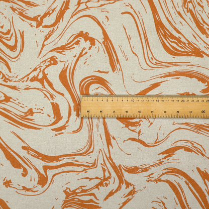 Abstract marbled fabric featuring fluid, organic swirls in a warm burnt orange colour over a textured cream-colored background.