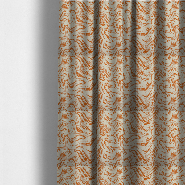 The fabric used to create these made-to-measure curtains is an abstract marbled fabric featuring fluid, organic swirls in a warm burnt orange colour over a textured cream-coloured background.