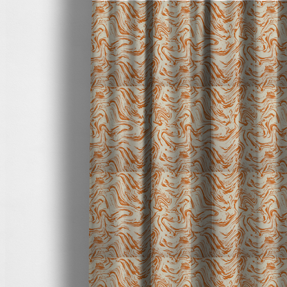 The fabric used to create these made-to-measure curtains is an abstract marbled fabric featuring fluid, organic swirls in a warm burnt orange colour over a textured cream-coloured background.
