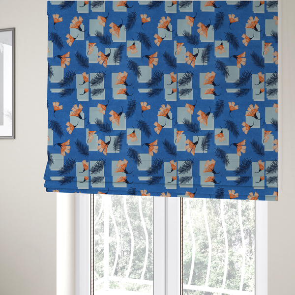 The fabric used to create these Roman blinds is a modern tropical fabric featuring a vibrant cobalt blue background with scattered orange fan-shaped flowers, dark navy palm fronds, and pale blue geometric square overlays.