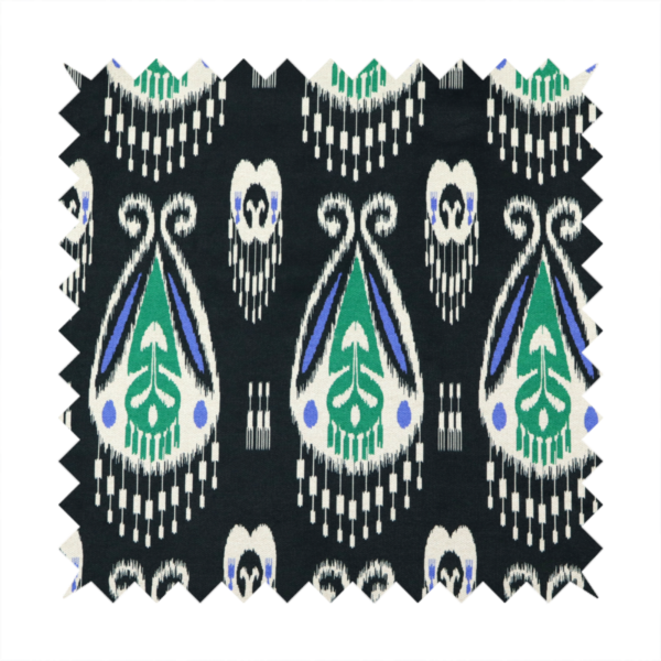 A dark textile featuring rows of floating, feathered ikat medallions. The design glows with emerald green and bright sapphire blue against a deep obsidian background, accented by crisp white geometric tassels and swirling crown-like scrollwork.