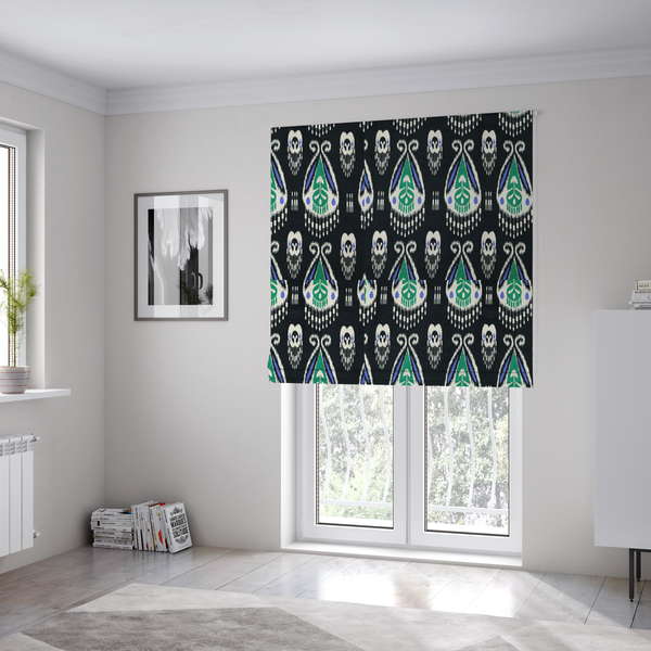 The fabric used to create these Roman blinds is a dark textile featuring rows of floating, feathered ikat medallions. The design glows with emerald green and bright sapphire blue against a deep obsidian background, accented by crisp white geometric tassels and swirling crown-like scrollwork.