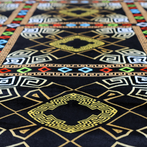 Luxury black fabric featuring a structured gold Greek Key and geometric medallion pattern, bordered by a vibrant row of small neon red, green, and blue diamond shapes.