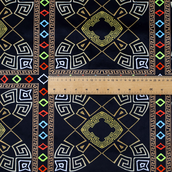 Luxury black fabric featuring a structured gold Greek Key and geometric medallion pattern, bordered by a vibrant row of small neon red, green, and blue diamond shapes.