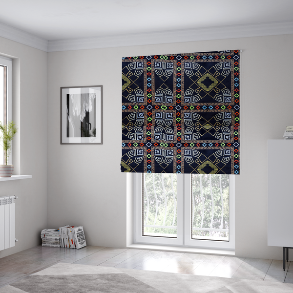 The fabric used to create these Roman blinds is a luxury black fabric featuring a structured gold Greek Key and geometric medallion pattern, bordered by a vibrant row of small neon red, green, and blue diamond shapes.