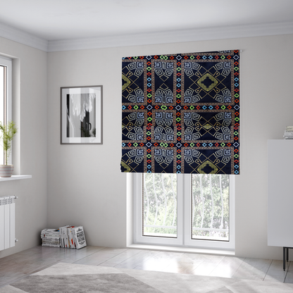The fabric used to create these Roman blinds is a luxury black fabric featuring a structured gold Greek Key and geometric medallion pattern, bordered by a vibrant row of small neon red, green, and blue diamond shapes.