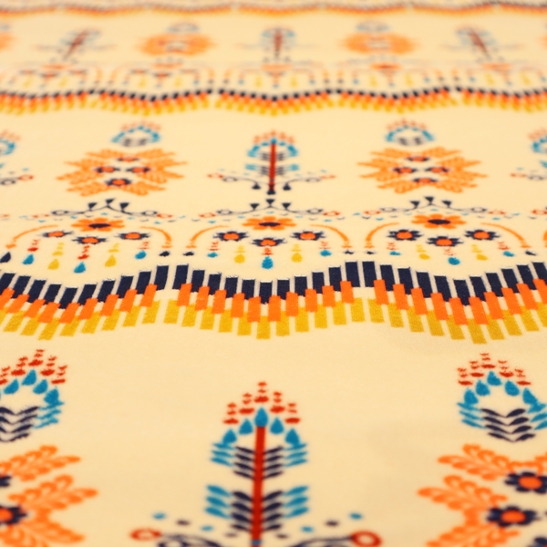 Folk-art style fabric featuring horizontal rows of stylized orange and navy floral pillars and geometric chevron borders on a warm cream background