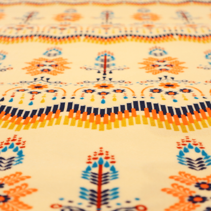 Folk-art style fabric featuring horizontal rows of stylized orange and navy floral pillars and geometric chevron borders on a warm cream background