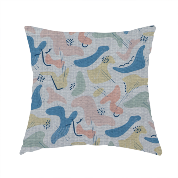 The fabric used to create this handmade cushion is a abstract mid-century modern fabric featuring fluid organic shapes in dusty blue, blush pink, and mustard yellow with fine black line accents and stippled dot clusters on a light grey linen-textured background.