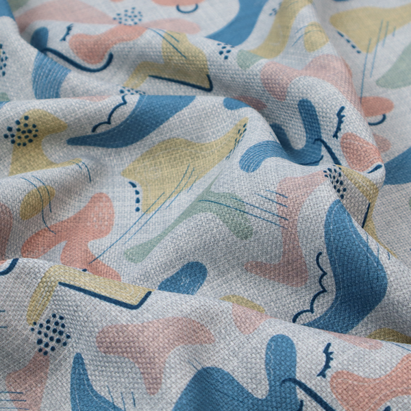Abstract mid-century modern fabric featuring fluid organic shapes in dusty blue, blush pink, and mustard yellow with fine black line accents and stippled dot clusters on a light grey linen-textured background.