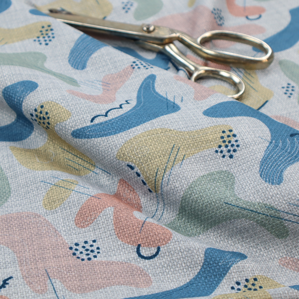 Abstract mid-century modern fabric featuring fluid organic shapes in dusty blue, blush pink, and mustard yellow with fine black line accents and stippled dot clusters on a light grey linen-textured background.