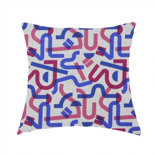 The fabric used to create this handmade cushion is an abstract pattern of overlapping blue and magenta ribbon-like curves and geometric shapes on a light grey textured fabric, creating dark purple tones at intersections.
