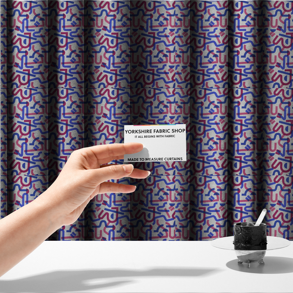 The fabric used to create these made-to-measure curtains is an abstract pattern of overlapping blue and magenta ribbon-like curves and geometric shapes on a light grey textured fabric, creating dark purple tones at intersections.