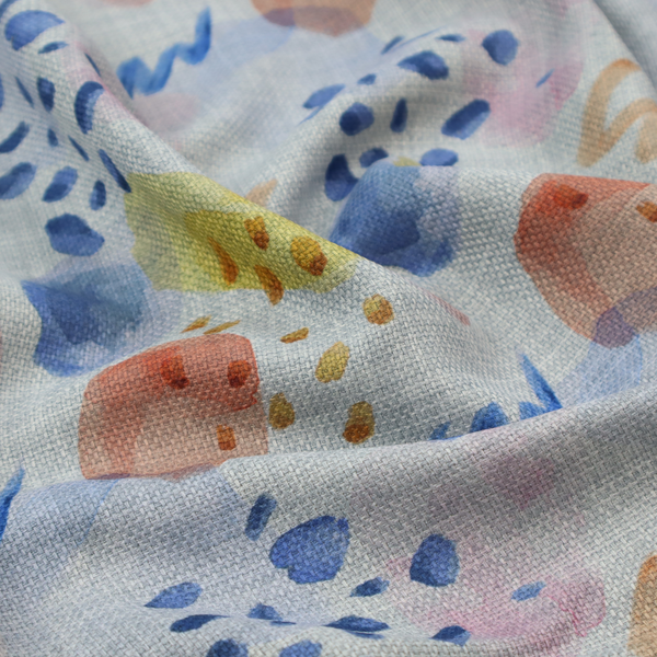 Abstract watercolour pattern of blue, ochre, and peach shapes with squiggly lines and navy dots on a light grey linen-textured background.