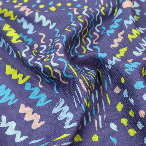 A dense abstract pattern featuring a variety of hand-drawn squiggles, dots, and dashes in bright, contrasting tones scattered across a deep, dark-coloured textured fabric.