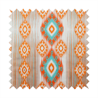 A striking geometric fabric featuring vibrant diamond medallions with blurred, ikat-style edges layered over a dynamic pattern of fine vertical streaks on a light background.
