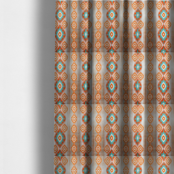 The fabric used to create these made-to-measure curtains is a striking geometric fabric featuring vibrant diamond medallions with blurred, ikat-style edges layered over a dynamic pattern of fine vertical streaks on a light background.