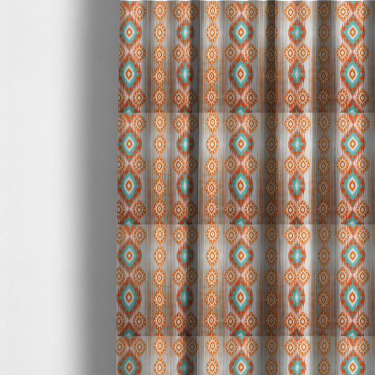 The fabric used to create these made-to-measure curtains is a striking geometric fabric featuring vibrant diamond medallions with blurred, ikat-style edges layered over a dynamic pattern of fine vertical streaks on a light background.