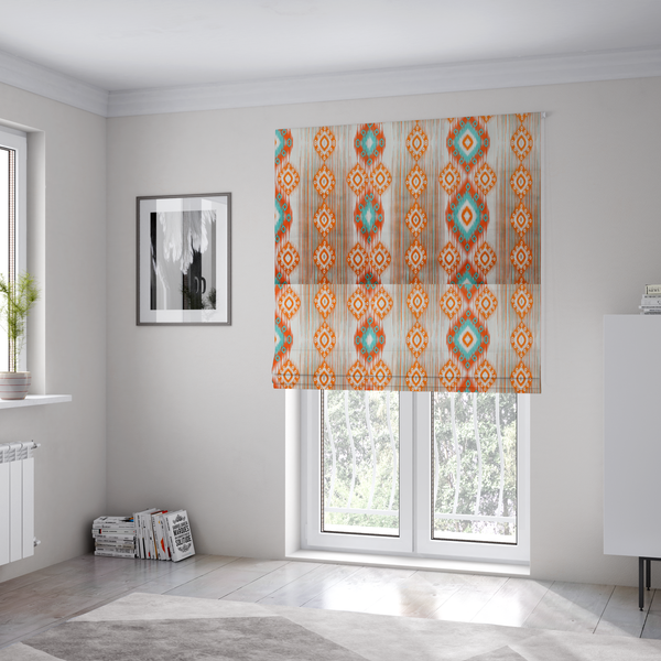 The fabric used to create these Roman blinds is a striking geometric fabric featuring vibrant diamond medallions with blurred, ikat-style edges layered over a dynamic pattern of fine vertical streaks on a light background.