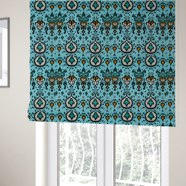 The fabric used to create these Roman blinds is a symmetrical folk-art pattern featuring large ornamental medallions and vertical tribal motifs with feathered, ikat-inspired edges on a solid, light-toned background.