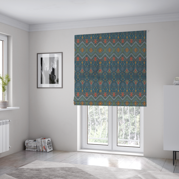 The fabric used to create these Roman blinds is an intricate geometric fabric featuring a central band of vibrant diamond motifs and tiered horizontal borders of tribal-style symbols and linework on a solid, deep-toned background.