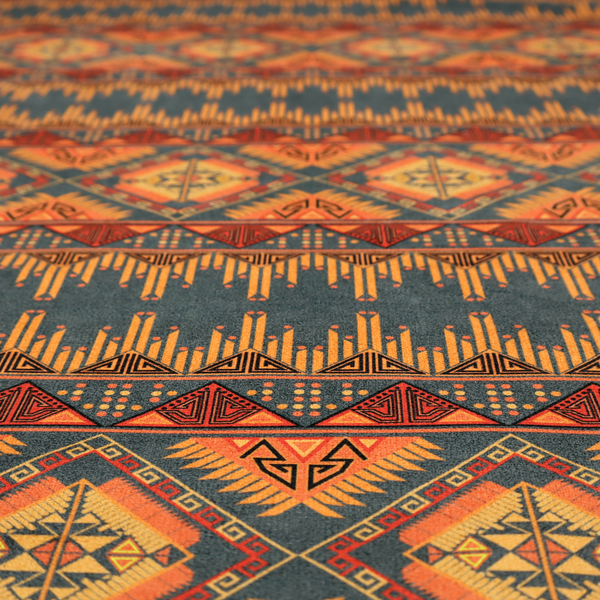 A detailed geometric fabric featuring tiered horizontal bands of intricate diamond motifs, zig-zag patterns, and sharp tribal-style linework in warm, sun-drenched tones.