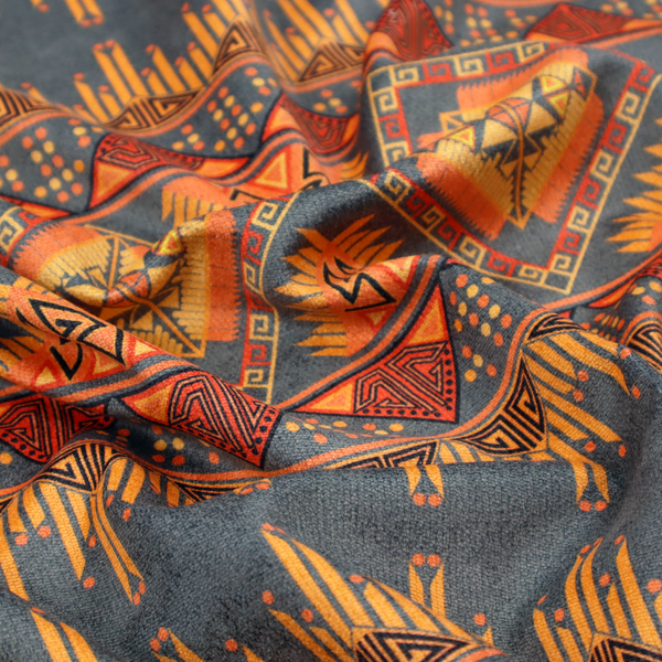 A detailed geometric fabric featuring tiered horizontal bands of intricate diamond motifs, zig-zag patterns, and sharp tribal-style linework in warm, sun-drenched tones.