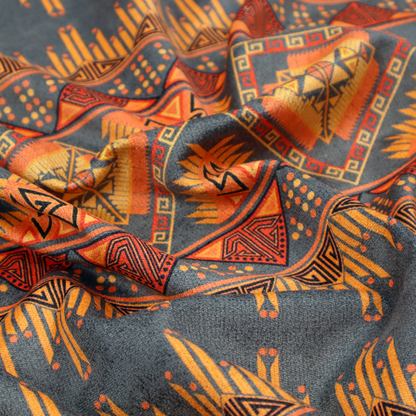 A detailed geometric fabric featuring tiered horizontal bands of intricate diamond motifs, zig-zag patterns, and sharp tribal-style linework in warm, sun-drenched tones.