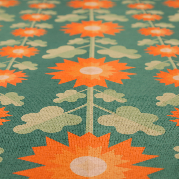 This fabric features a retro-inspired geometric floral pattern with a distinct mid-century modern aesthetic. The design is structured in vertical columns against a textured, deep teal-green background.