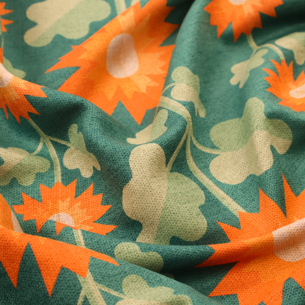 This fabric features a retro-inspired geometric floral pattern with a distinct mid-century modern aesthetic. The design is structured in vertical columns against a textured, deep teal-green background.