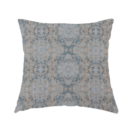 The fabric used to create this handmade cushion is a woven fabric featuring a symmetrical, repeating abstract pattern with a marble-like swirl effect in muted tones of dusty blue, sandy tan, and soft grey.