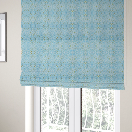 The fabric used to create these Roman blinds is a  repeating, symmetrical pattern of fluid, marble-like swirls in shades of sky blue, white, and subtle golden-yellow on a light blue background.
