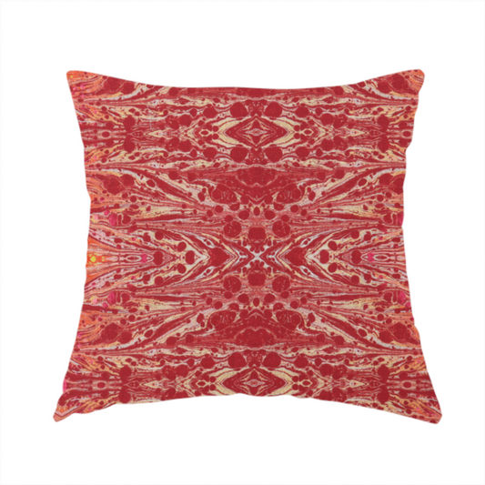 The fabric used to create this handmade cushion is a repeating, symmetrical pattern of fluid, marble-like swirls in rich shades of deep red, fiery orange, and bright yellow on a textured fabric background.