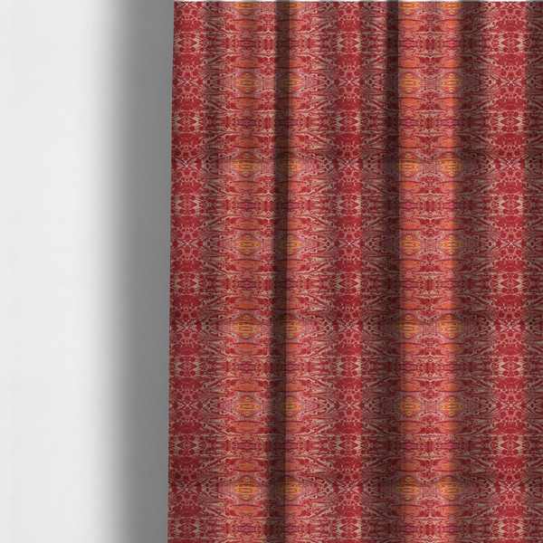The fabric used to create these made-to-measure curtains is a repeating, symmetrical pattern of fluid, marble-like swirls in rich shades of deep red, fiery orange, and bright yellow on a textured fabric background.