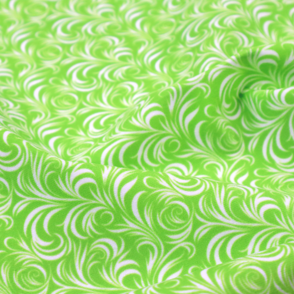 A vibrant, lime-green fabric featuring a dense, repeating pattern of elegant, white, swirling botanical motifs