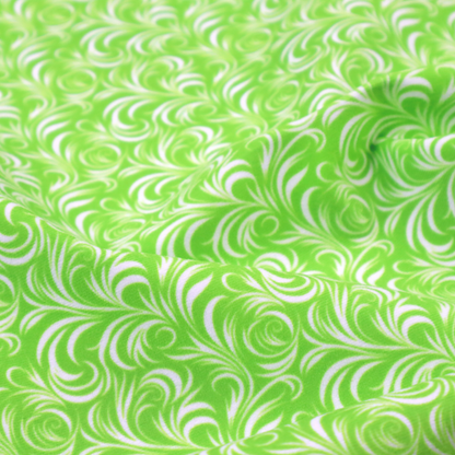A vibrant, lime-green fabric featuring a dense, repeating pattern of elegant, white, swirling botanical motifs