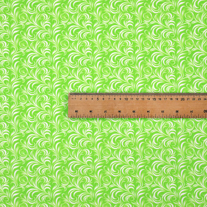 A vibrant, lime-green fabric featuring a dense, repeating pattern of elegant, white, swirling botanical motifs