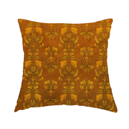 The fabric used to create this handmade cushion is an ornate, vintage-style damask fabric featuring repeating, intricate botanical motifs in rich shades of burnt orange, gold, and deep brown with a subtly aged, textured appearance.