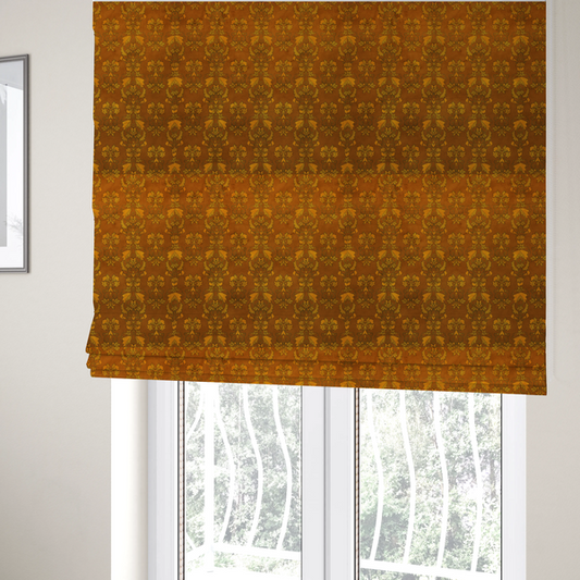 The fabric used to create these Roman blinds is an ornate, vintage-style damask fabric featuring repeating, intricate botanical motifs in rich shades of burnt orange, gold, and deep brown with a subtly aged, textured appearance.