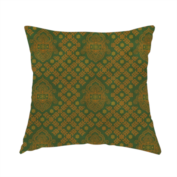 The fabric used to create this handmade cushion is a repeating, decorative fabric pattern featuring ornate, gold-toned paisley motifs centred on a deep forest green background. The design is structured around a subtle lattice of small, delicate floral sprigs, creating a traditional, block-printed aesthetic with a slightly weathered, vintage texture.
