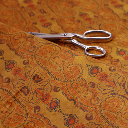 A warm, vintage-style paisley pattern with a weathered, antique tapestry aesthetic.