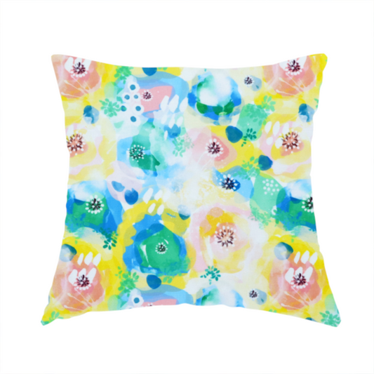 The fabric used to create this handmade cushion is a vibrant, watercolour floral pattern with a bright and airy spring aesthetic.