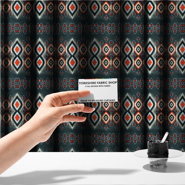 The fabric used to create these made-to-measure curtains is a bold, high-contrast Ikat textile pattern with a modern tribal aesthetic.