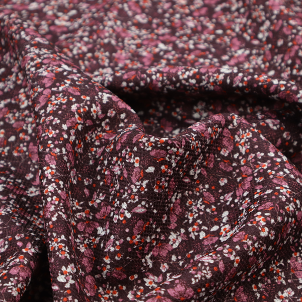 A dense, monochromatic ditsy floral pattern with a rich, romantic aesthetic.