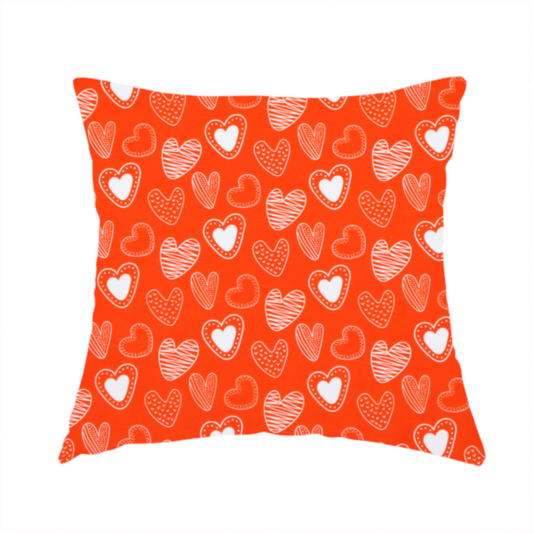 The fabric used for this handmade cushion is a vibrant red fabric features a playful, repeating pattern of white heart illustrations. The hearts are hand-drawn in several distinct styles, including solid outlines with dotted borders, sketched diagonal stripes, and intricate stippled patterns. These varied heart motifs are scattered across the bright background at different angles, creating a lively and energetic design.