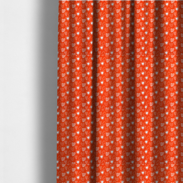 The fabric used to create these made-to-measure curtains is a vibrant red fabric features a playful, repeating pattern of white heart illustrations. The hearts are hand-drawn in several distinct styles, including solid outlines with dotted borders, sketched diagonal stripes, and intricate stippled patterns. These varied heart motifs are scattered across the bright background at different angles, creating a lively and energetic design.