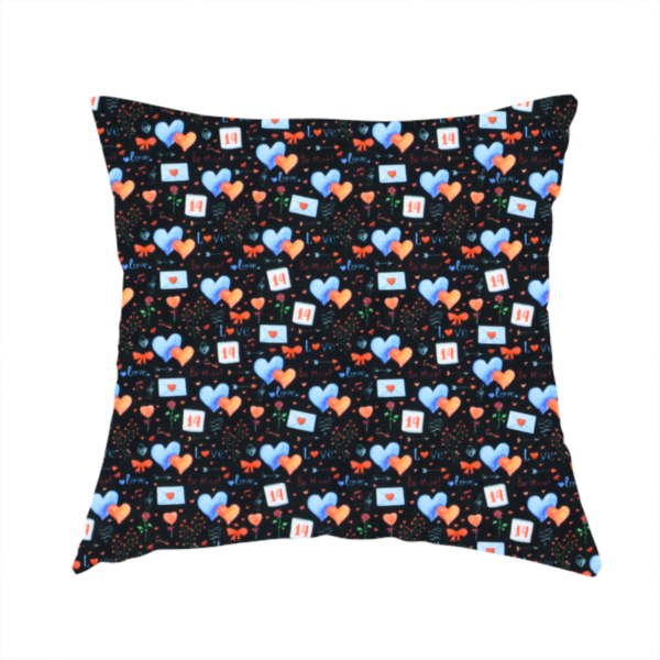The fabric used to create this handmade cushion is a black fabric features a dense, romantic Valentine’s Day theme with a repeating pattern of watercolour-style motifs. The design includes blue and red hearts, small sealed envelopes, red bows, and calendar pages marked with the number "14". 