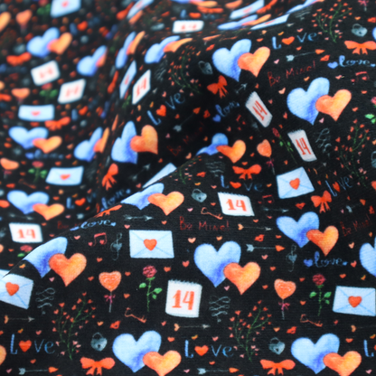 This black fabric features a dense, romantic Valentine’s Day theme with a repeating pattern of watercolour-style motifs. The design includes blue and red hearts, small sealed envelopes, red bows, and calendar pages marked with the number "14". 