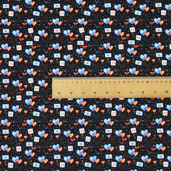 This black fabric features a dense, romantic Valentine’s Day theme with a repeating pattern of watercolour-style motifs. The design includes blue and red hearts, small sealed envelopes, red bows, and calendar pages marked with the number "14". 